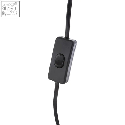 Black rectangular toggle switch with matte finish on cord of padma table lamp with acrylic base