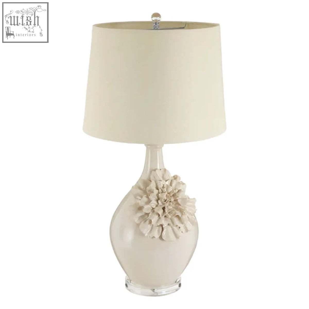 Cream-colored padma table lamp with acrylic base and sculpted floral accent and matching drum shade