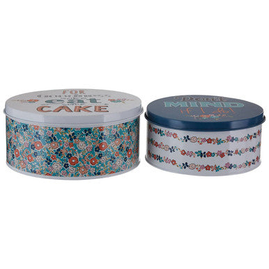Two round cake tins from paice pretty things featuring floral and striped designs with white and navy lids for cakes