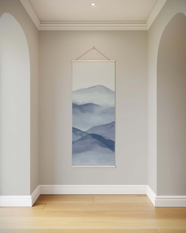 Minimalist painted mountain tapestry with layered blue and gray mountain ranges framed in white for art deco wall decor