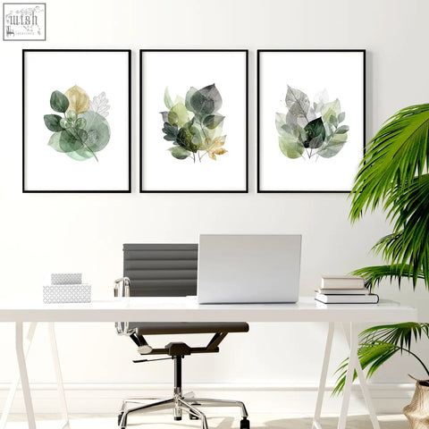 Three framed botanical wall art prints with green and gold watercolor leaves in black frames for home office decor