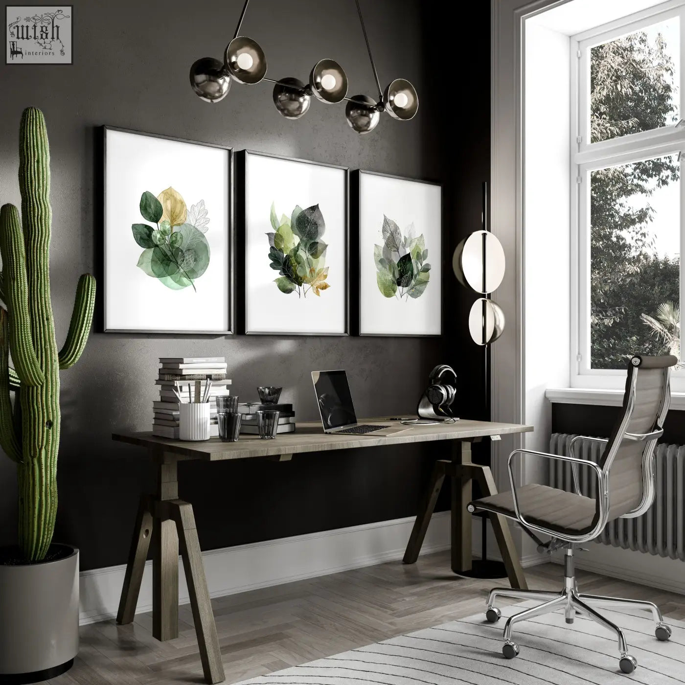 Three framed botanical wall art prints with green and gold leaves hanging above a wooden home office desk