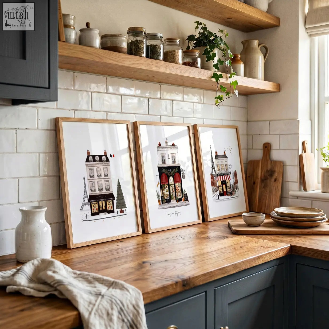 Three wooden framed parisian-themed wall art featuring street scenes titled paris pour toujours on a kitchen counter