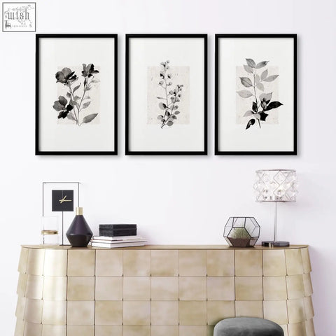 Three black-framed french country botanical wall art prints with ivory grey floral ink illustrations for living room decor