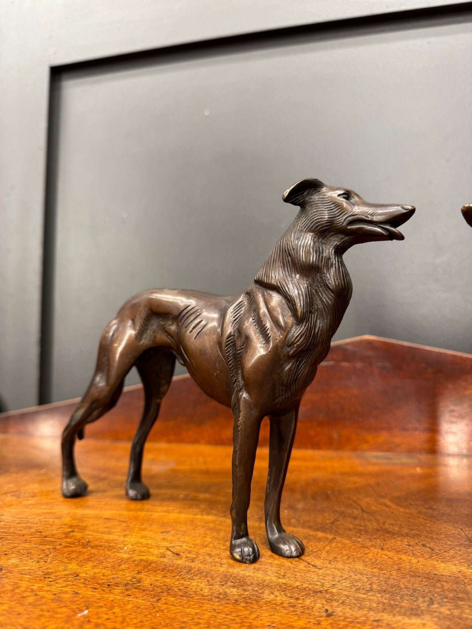 Bronze greyhound figurine with detailed fur texture and elegant posture perfect as a dog ornament or statue
