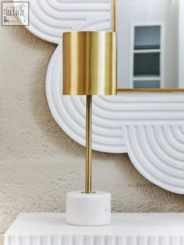 Palais table lamp with a gold cylinder and sleek white marble base perfect for modern home decor