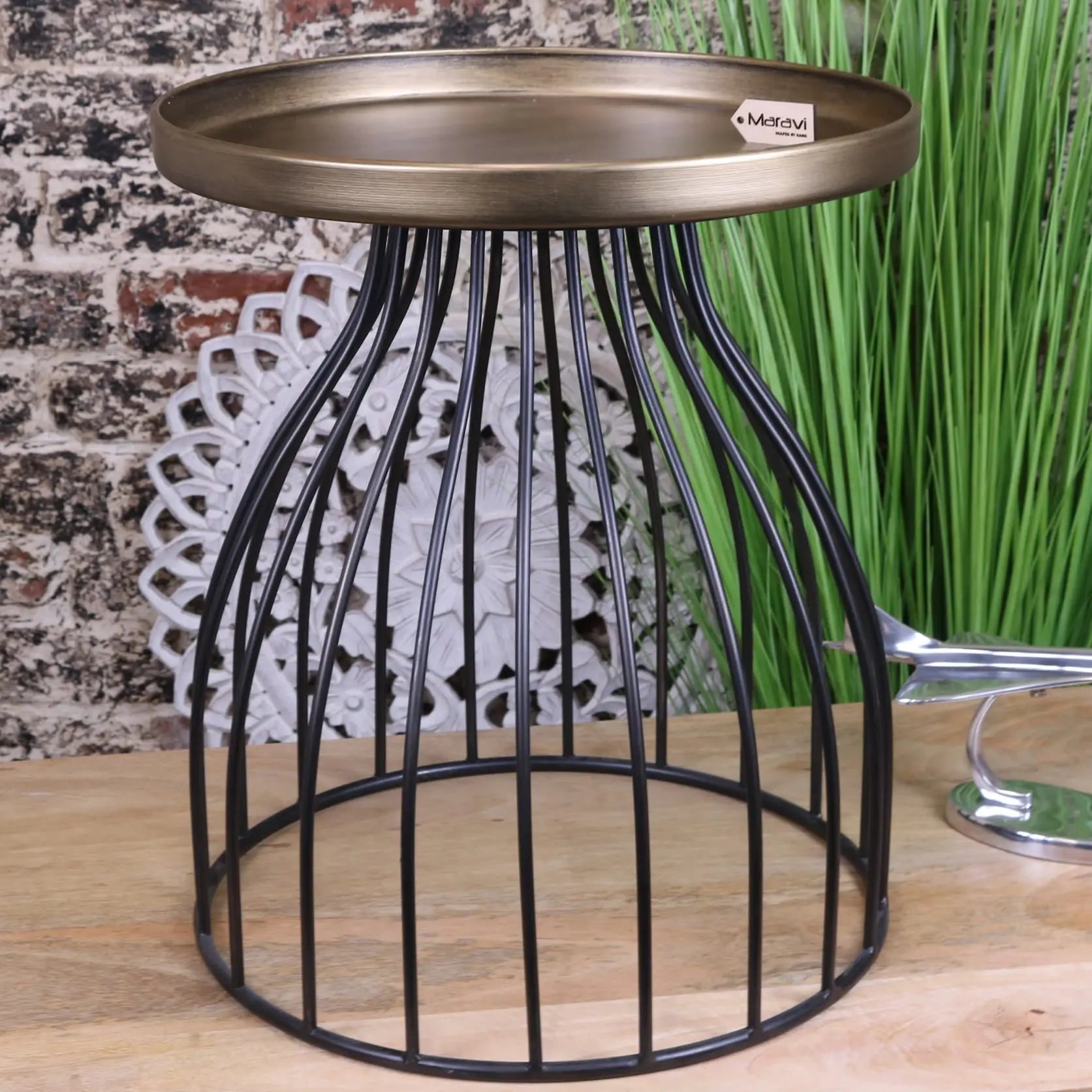 Black metal wireframe palampur industrial round side table with a luxurious gold tabletop and bronze circular top