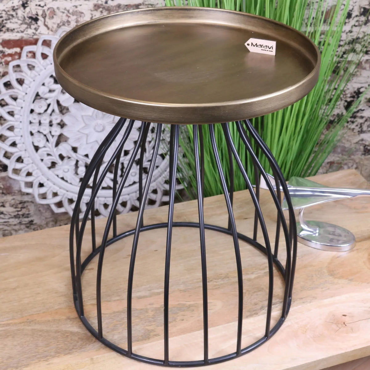Bronze finished metal tray with black wire cage base on palampur gold industrial round side table with luxurious gold tabletop