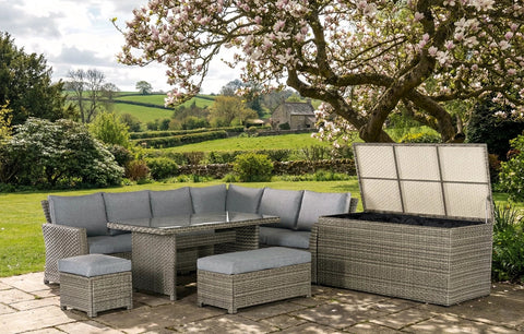 Gray woven wicker rattan garden lounge set with corner sofa, matching ottomans, and glass-top table for outdoor use