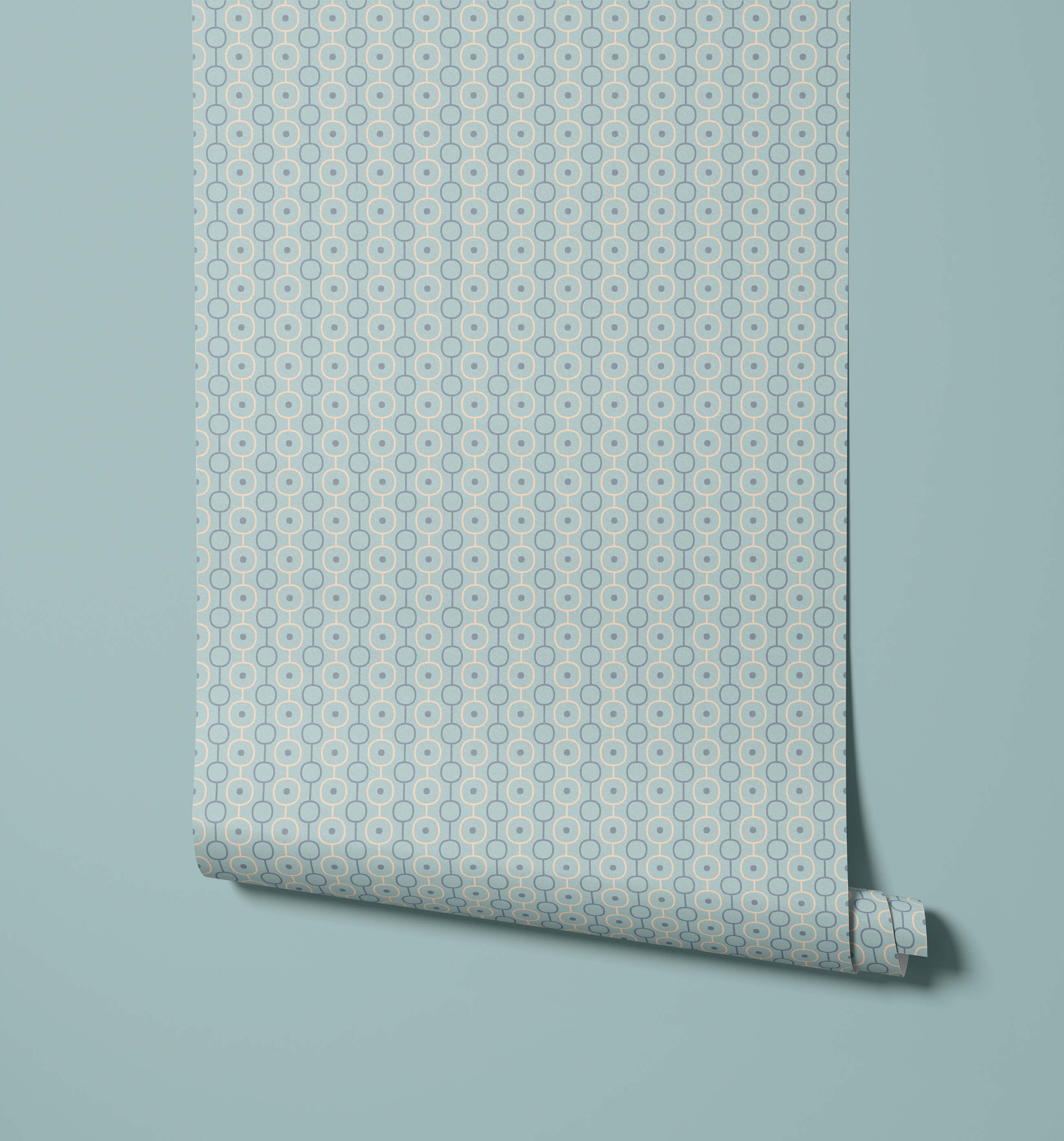A roll of palna light blue wallpaper with a repeating geometric pattern of interconnected darker circles