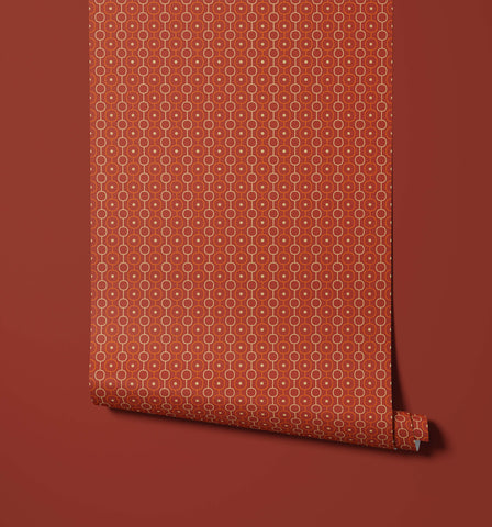 A roll of palna terracotta wallpaper with a repeating white circle and dot pattern for stylish walls