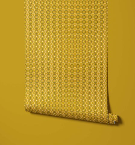 A roll of palna mustard-yellow wallpaper with a repeating pattern of lighter yellow and dark olive green circles