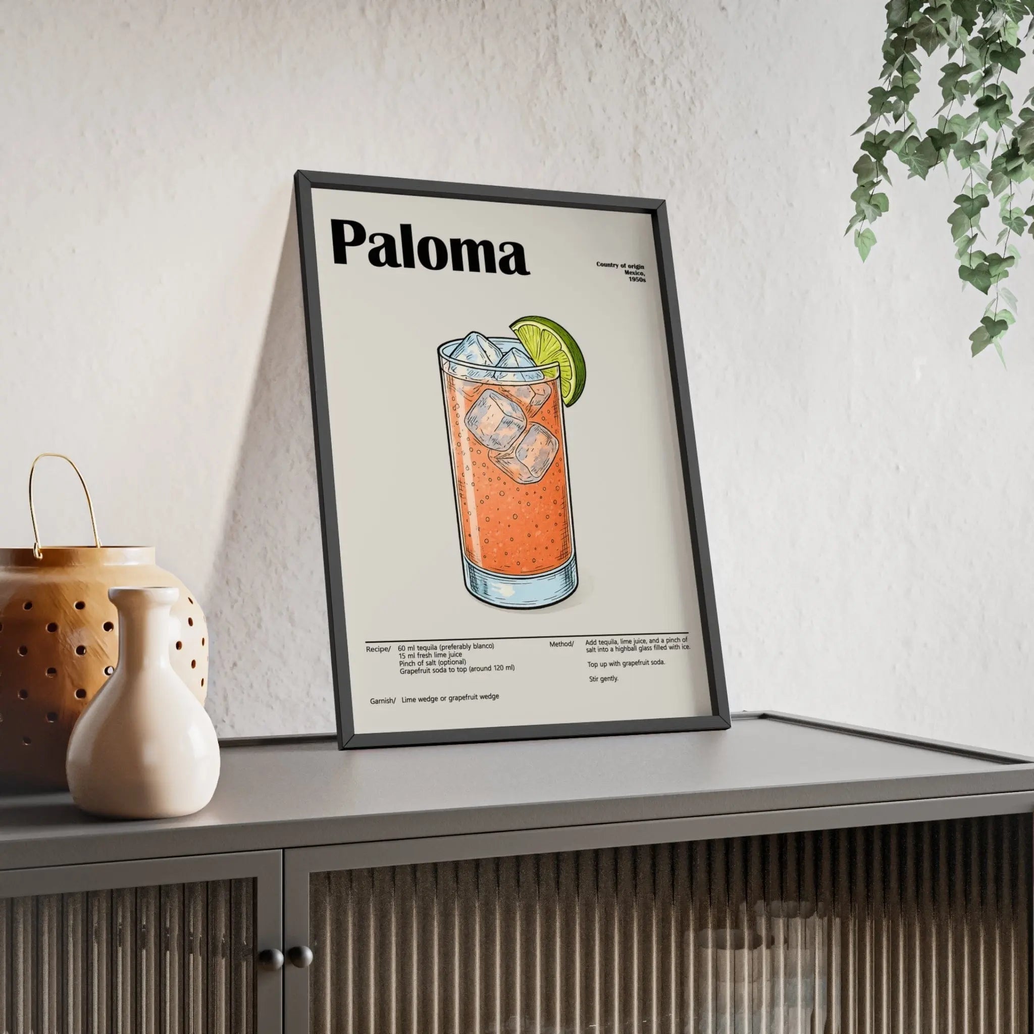 Black-framed paloma cocktail poster with orange drink, ice cubes, and lime wedge perfect for fresh tequila drink wall art