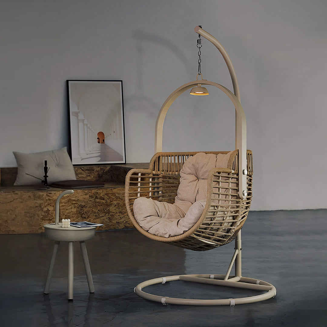 Beige woven rattan garden hanging egg chair with cushion and metal frame from paloma rattan garden collection
