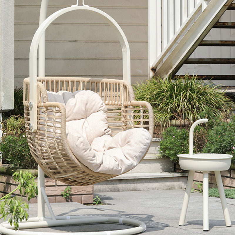 Beige paloma rattan garden hanging egg chair with cream cushions and white metal frame for indoor outdoor use
