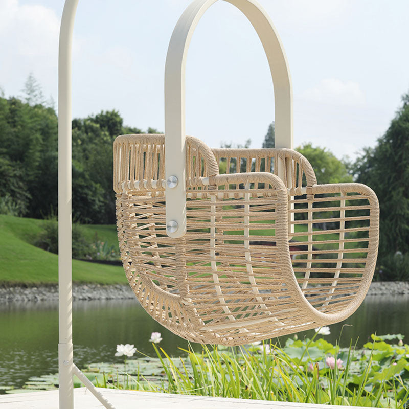 Beige woven rattan garden hanging egg chair with curved handle and metal hardware for indoor outdoor use Paloma Rattan Garden