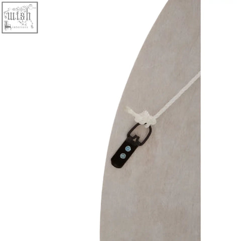 Black plastic clip with three silver dots on white string of palu natural shell round wall mirror back side
