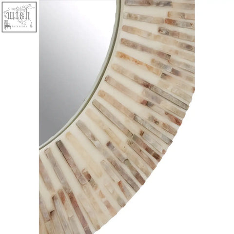 Palu natural shell round wall mirror with a sunburst frame made of weathered bone and shell in creamy white tones
