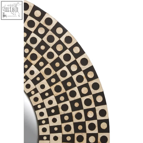 Palu round black wall mirror with shell inlay features a decorative frame of black and cream squares with circles