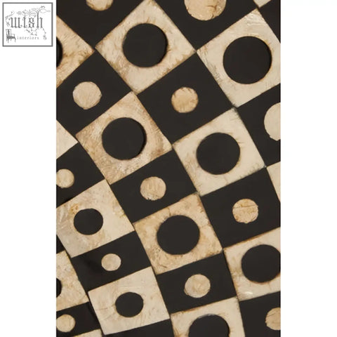Black and cream geometric fabric with circular motifs featured in palu round black wall mirror with shell inlay