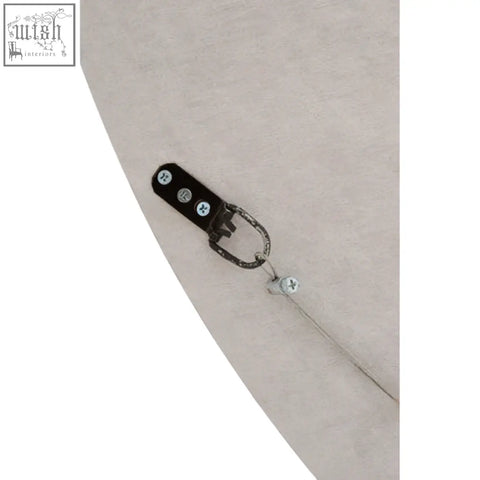 Back of round black wall mirror showing black metal clip with three silver screws and attached chain for hanging