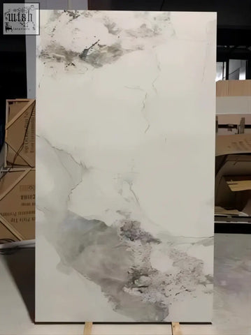 A large rectangular white marble sintered stone slab with gray veining and a gloss finish called pandora gloss finish