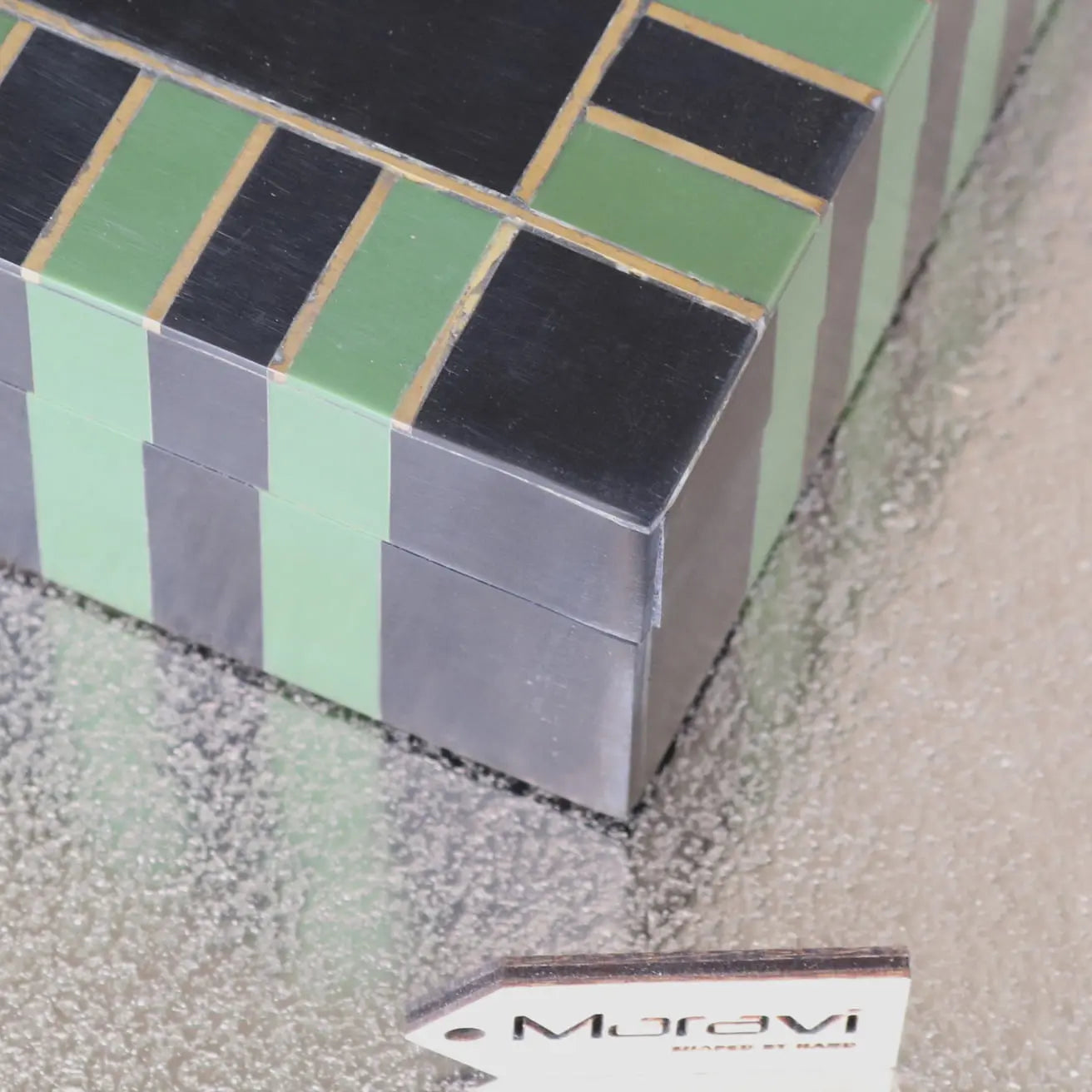 A panna luxe resin jewellery box with sleek black and mint green panels accented by thin gold lines in luxe resin design