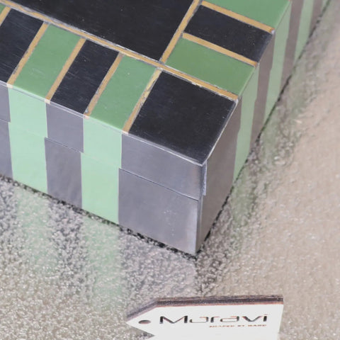 A panna luxe resin jewellery box with sleek black and mint green panels accented by thin gold lines in luxe resin design