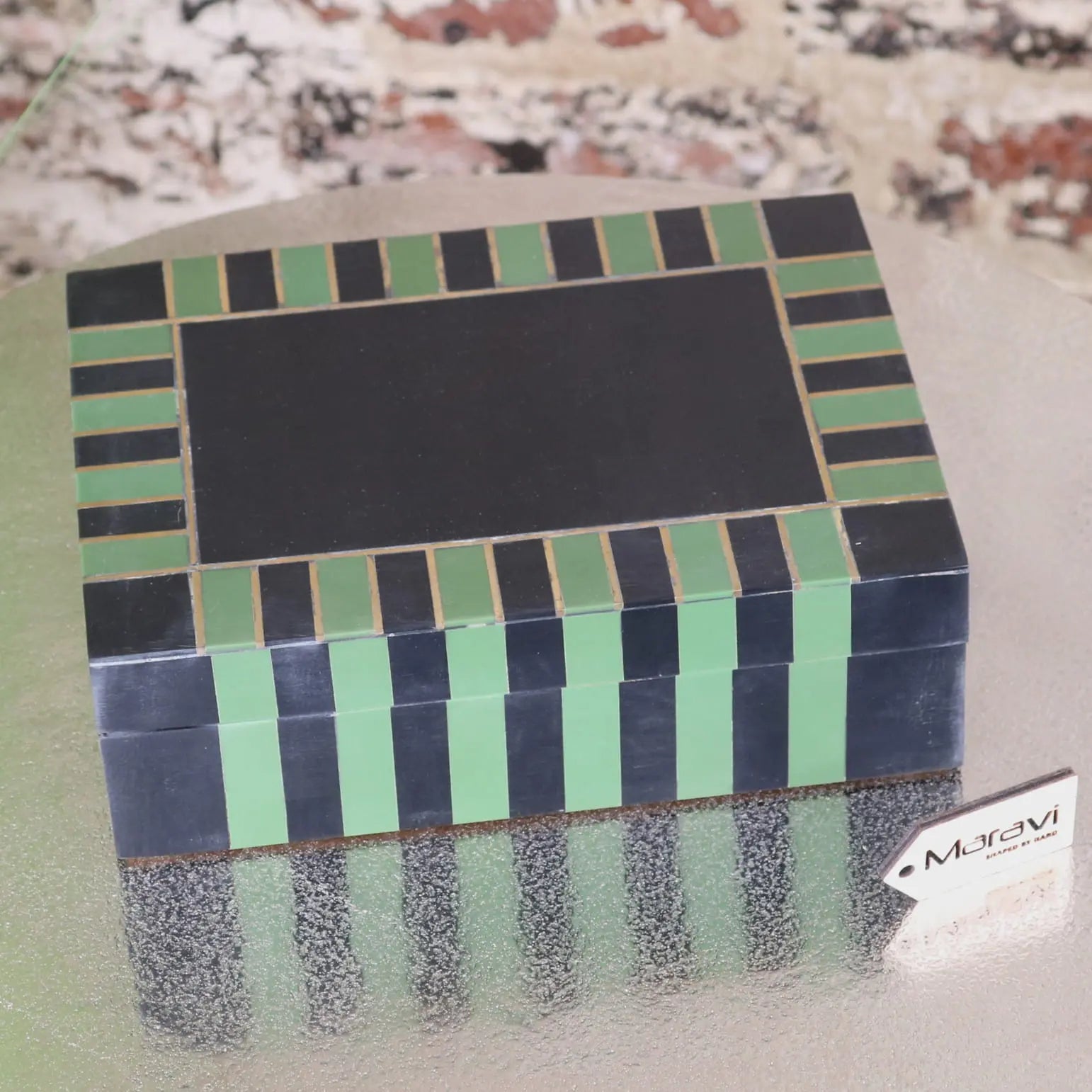 A rectangular panna luxe resin jewellery box with black and mint green tiles framed by thin gold lines