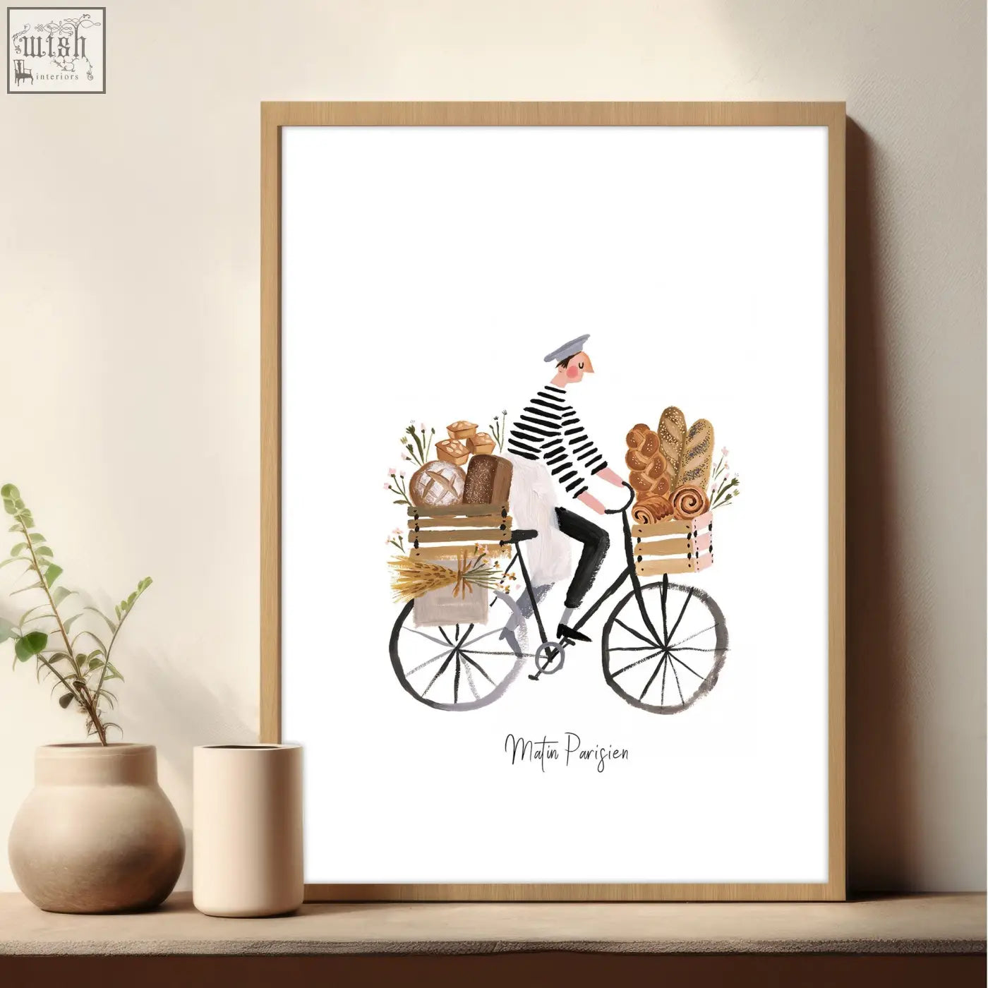 A framed watercolor wall art in brown tones showing a man in a striped shirt riding a bread-loaded bike matin parisien style