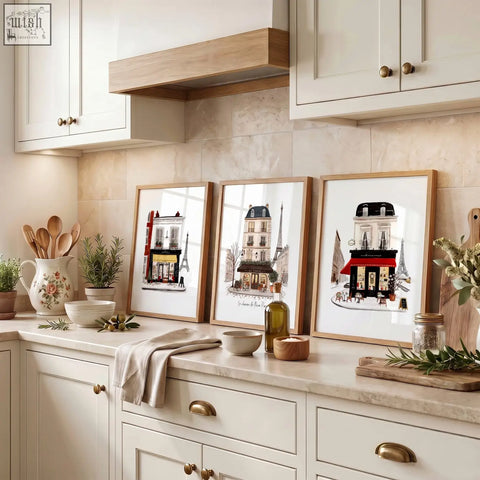 Three parisian-themed art prints with illustrated buildings and eiffel tower in light wood frames for kitchen art
