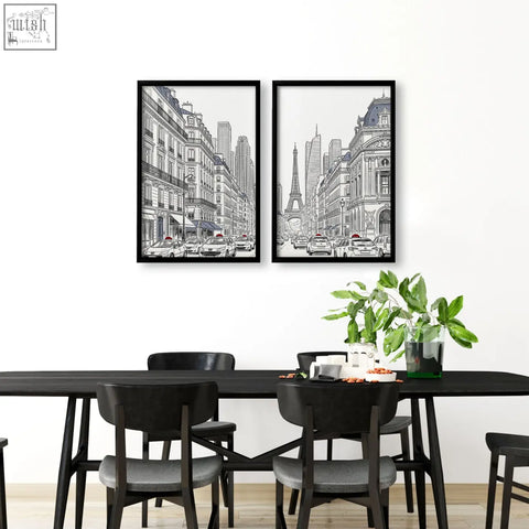 Two black-framed paris prints black with red accent showing parisian streets and the eiffel tower above a dining room table