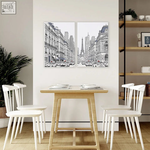 Two black and white paris prints with red accent showing eiffel tower streets above wooden dining room table