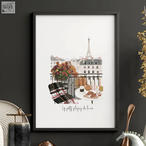 Black-framed art piece featuring a parisian balcony with eiffel tower and autumn flowers in warm beige tones from les petits plaisirs
