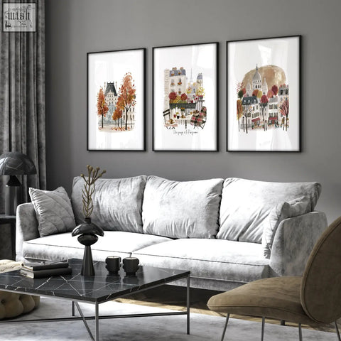 Gray velvet sofa with plush cushions next to paris travel living room wall art prints set of 3 autumn designs