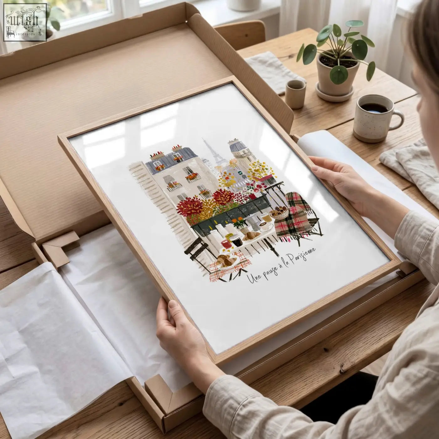 A framed paris travel wall art piece featuring a colorful watercolor parisian street scene with café tables and flowers