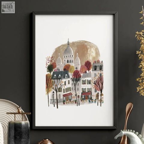 Black-framed wall art piece showing a stylized parisian street with autumn trees and sacré-cœur basilica in paris travel set