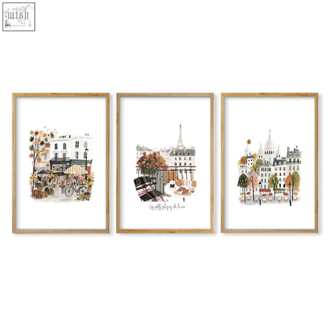 Set of three framed paris wall art prints with autumn watercolor scenes in light wood frames for home decor