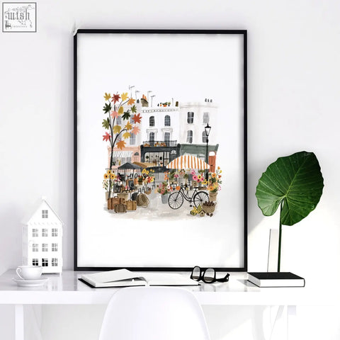Black-framed paris wall art featuring autumnal street scene with colorful flowers and charming buildings in watercolor style