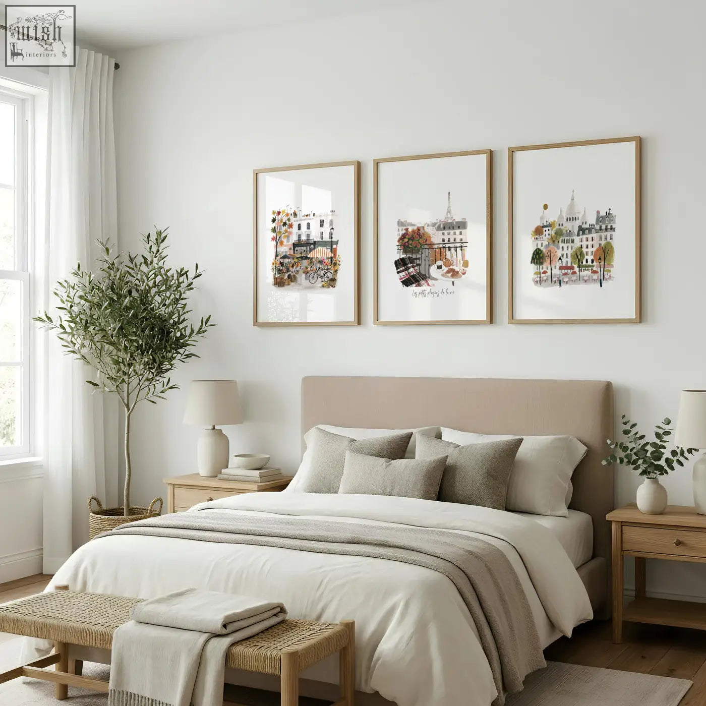 Three framed paris wall art prints with autumn watercolor cityscape illustrations in light wood frames above bed