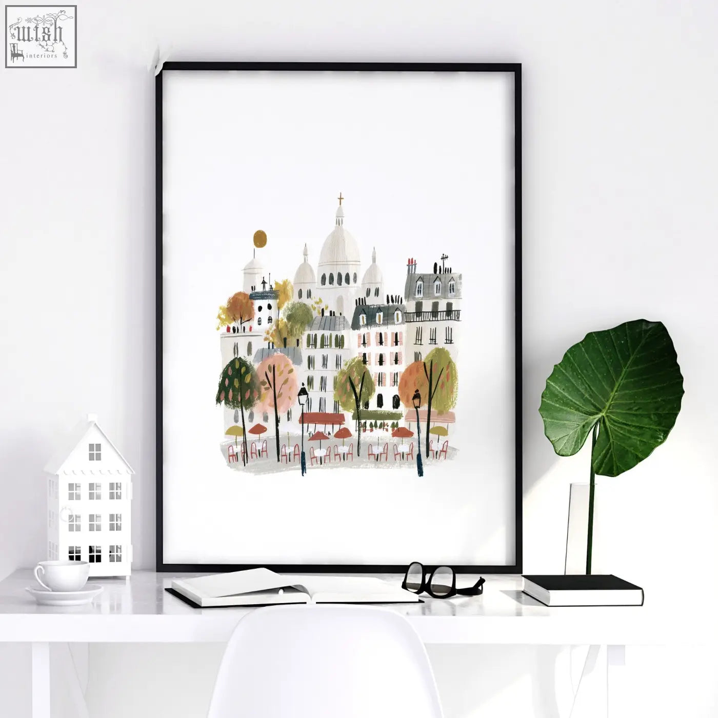 A framed paris wall art featuring pastel buildings autumn trees and cafe tables in a set of 3 scenes