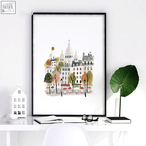 A framed paris wall art featuring pastel buildings autumn trees and cafe tables in a set of 3 scenes