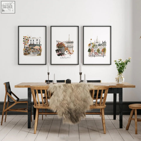 Three framed paris wall art prints with eiffel tower and autumn scenes hang above wooden dining table