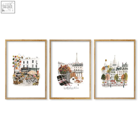 Set of three framed paris wall art prints with autumn parisian scenes in light wood frames for living room decor