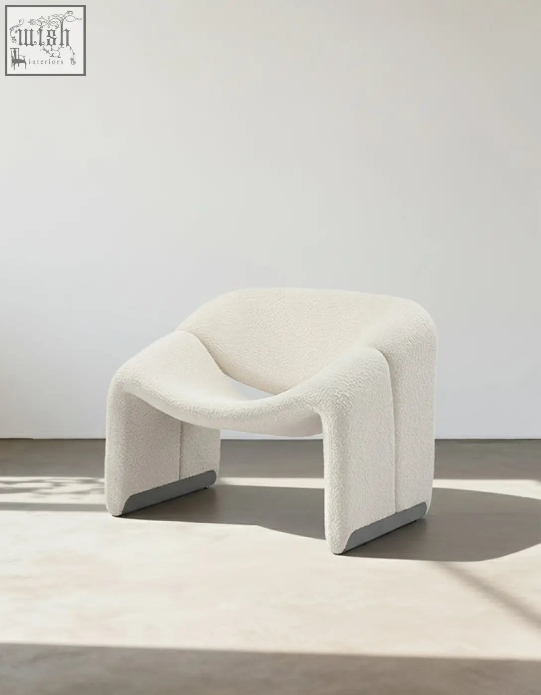 Cream-colored paris wawa boucle armchair with plush texture sleek curves and gray metallic feet for modern living