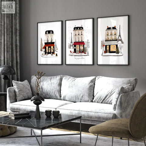Three framed paris winter street scene living room wall art canvas featuring black and red storefront illustrations above sofa