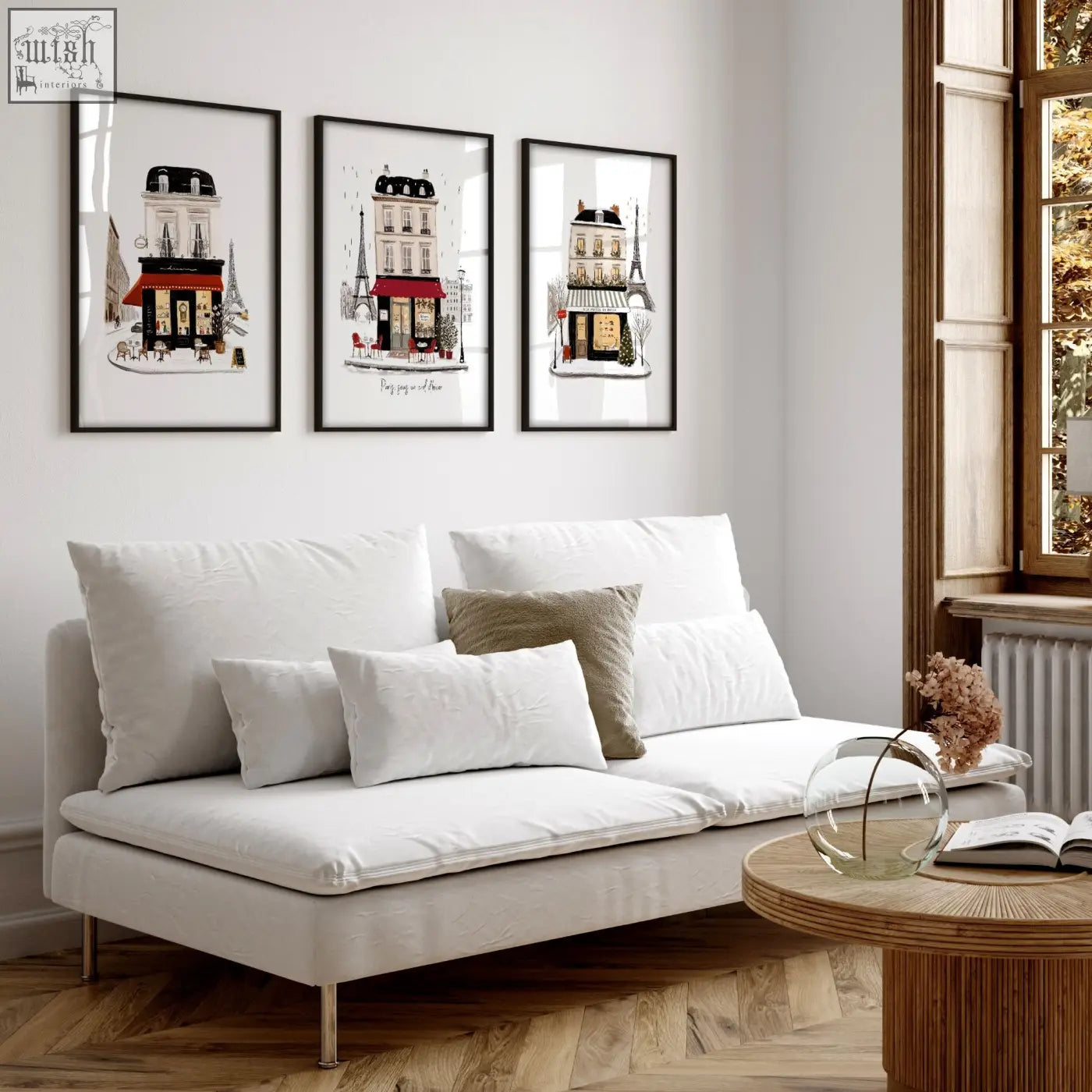 White upholstered sofa with metallic legs and cushions in a paris winter street scene living room wall art set
