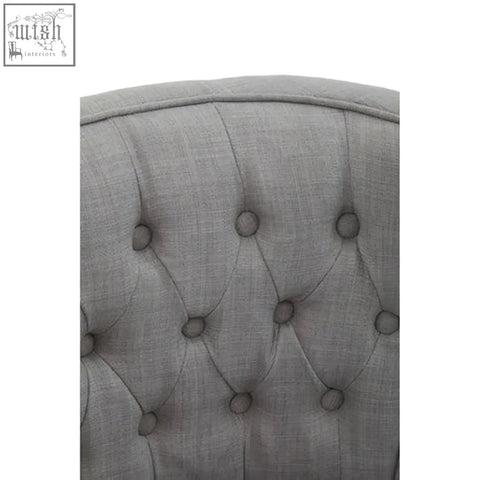 Back side of parkside grey fabric curved dining chair with grey tufted fabric and button details