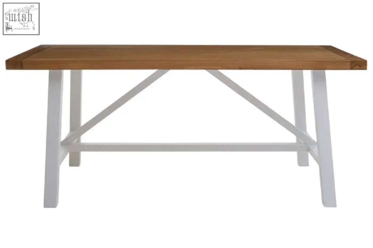 Parkside natural oak dining table with a light brown wooden top and white metal legs with x-shaped cross-brace design