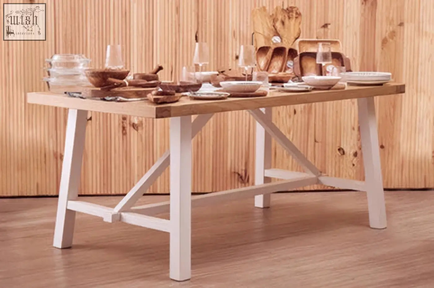 Wooden parkside natural oak dining table with white painted legs and ceramic dishes on natural oak top